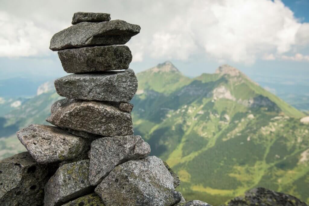 A stack of granite stones overlooking a mountain range.