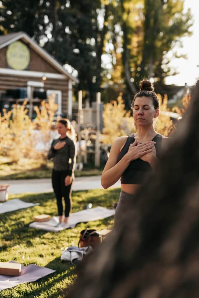 Women doing yoga in a park.