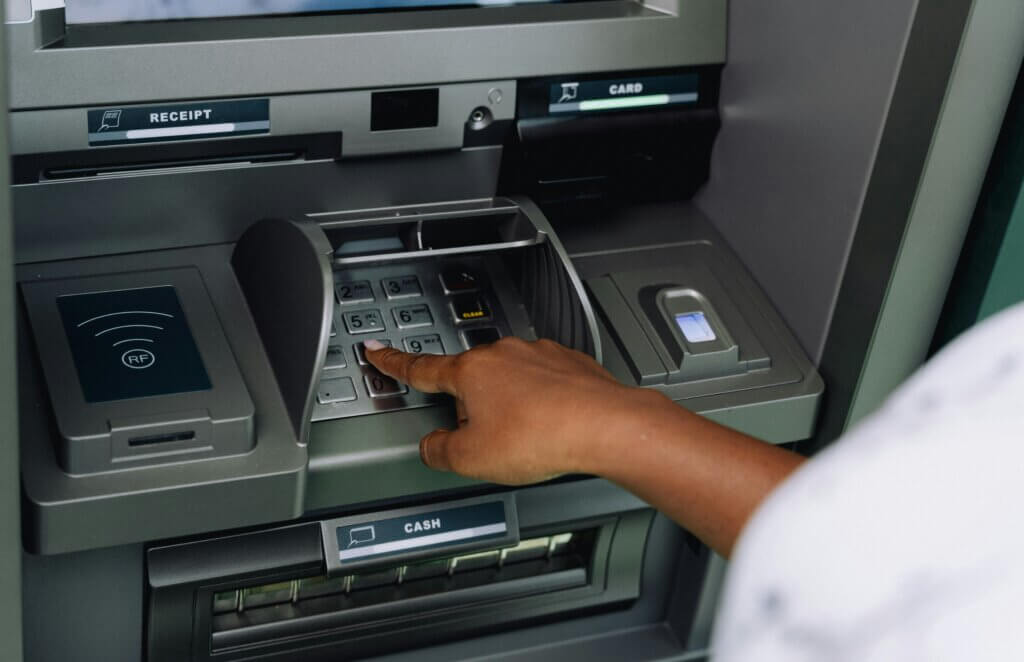 Person using an ATM machine.