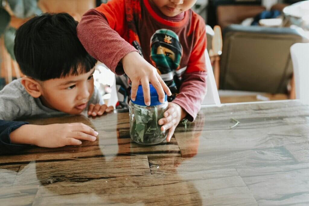Two children with a jar of money