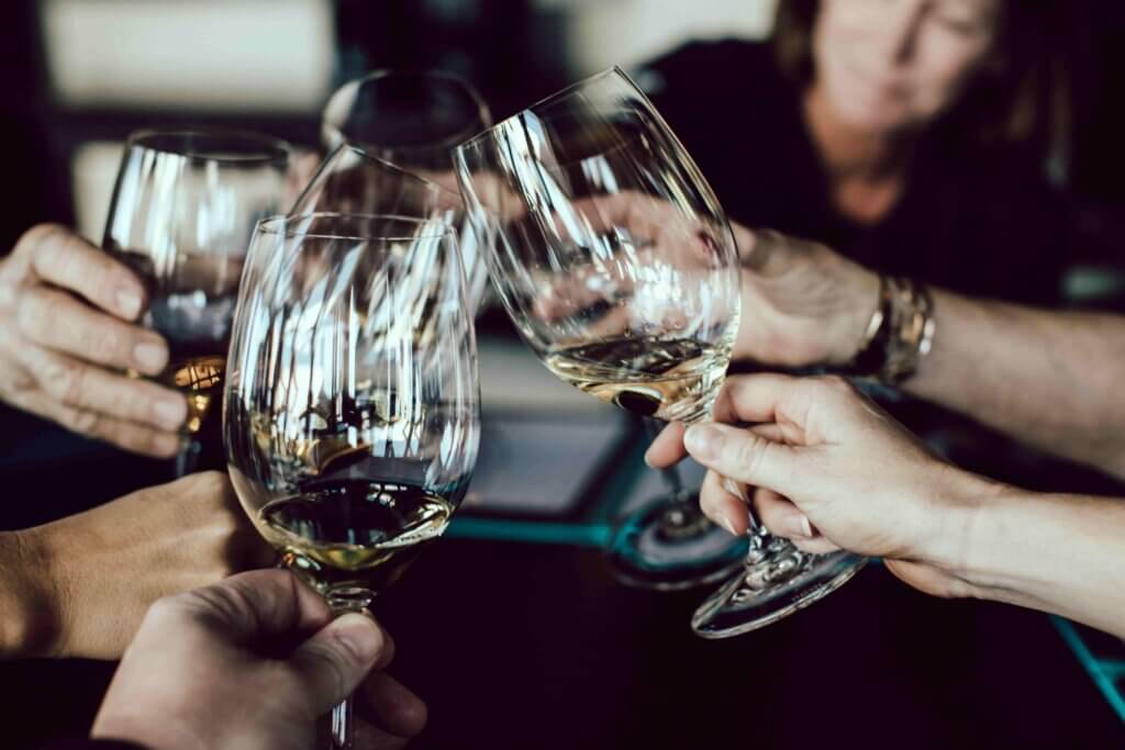 A group of people toasting with wine glasses.